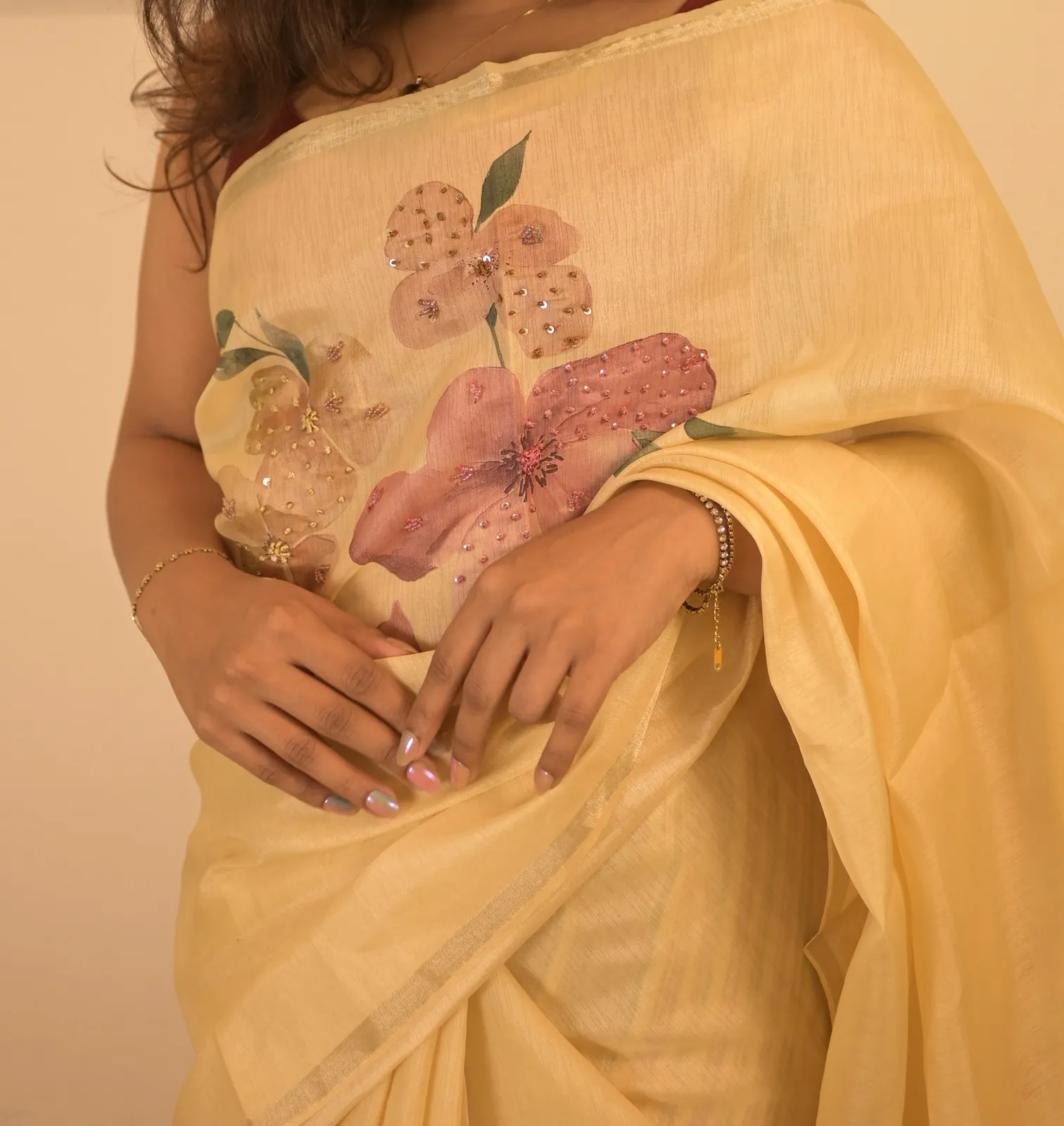 Creamy white chanderi saree with printed florals and hand work