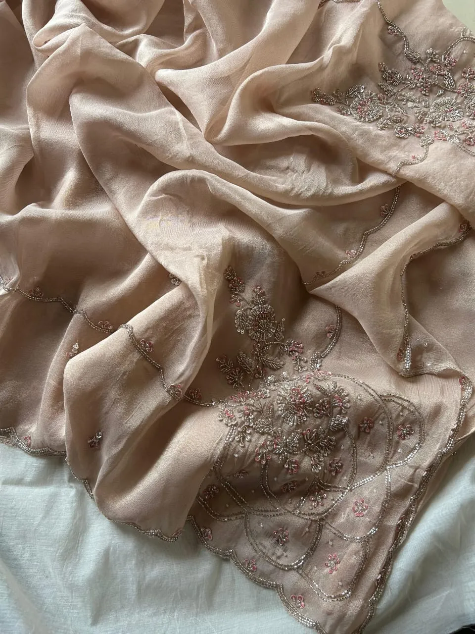 Peach tissue silk saree with hand embroidery, close-up
