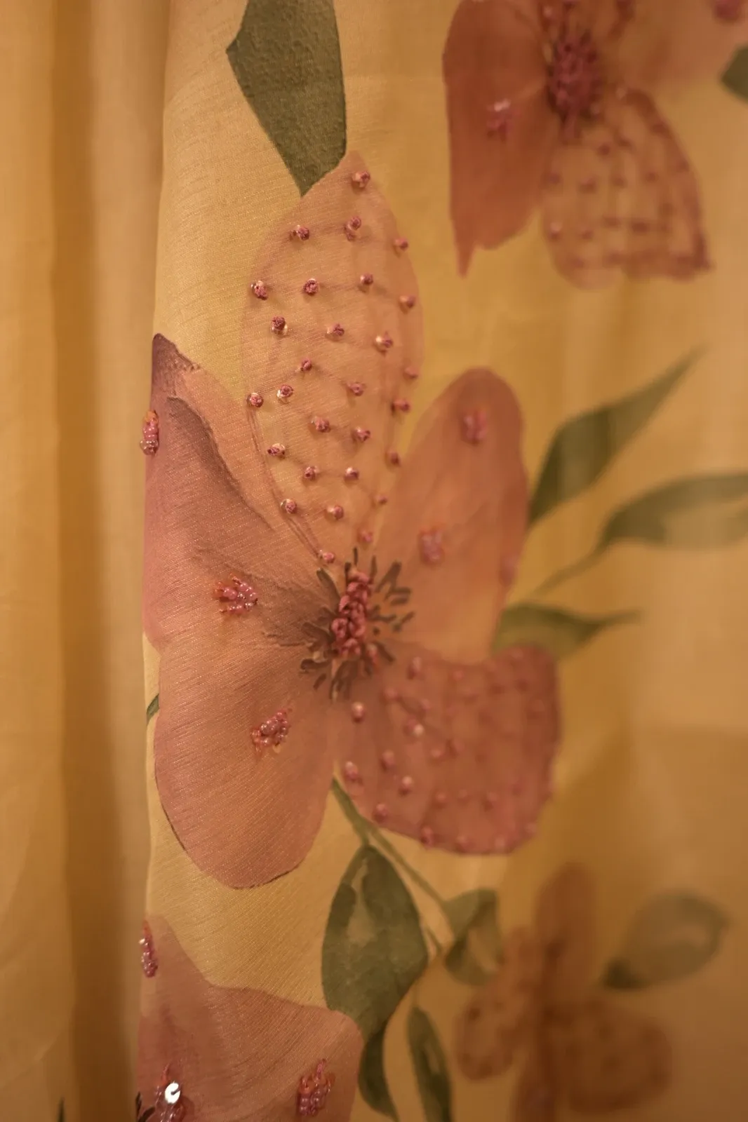 Close-up of a printed flower with bead and sequin work