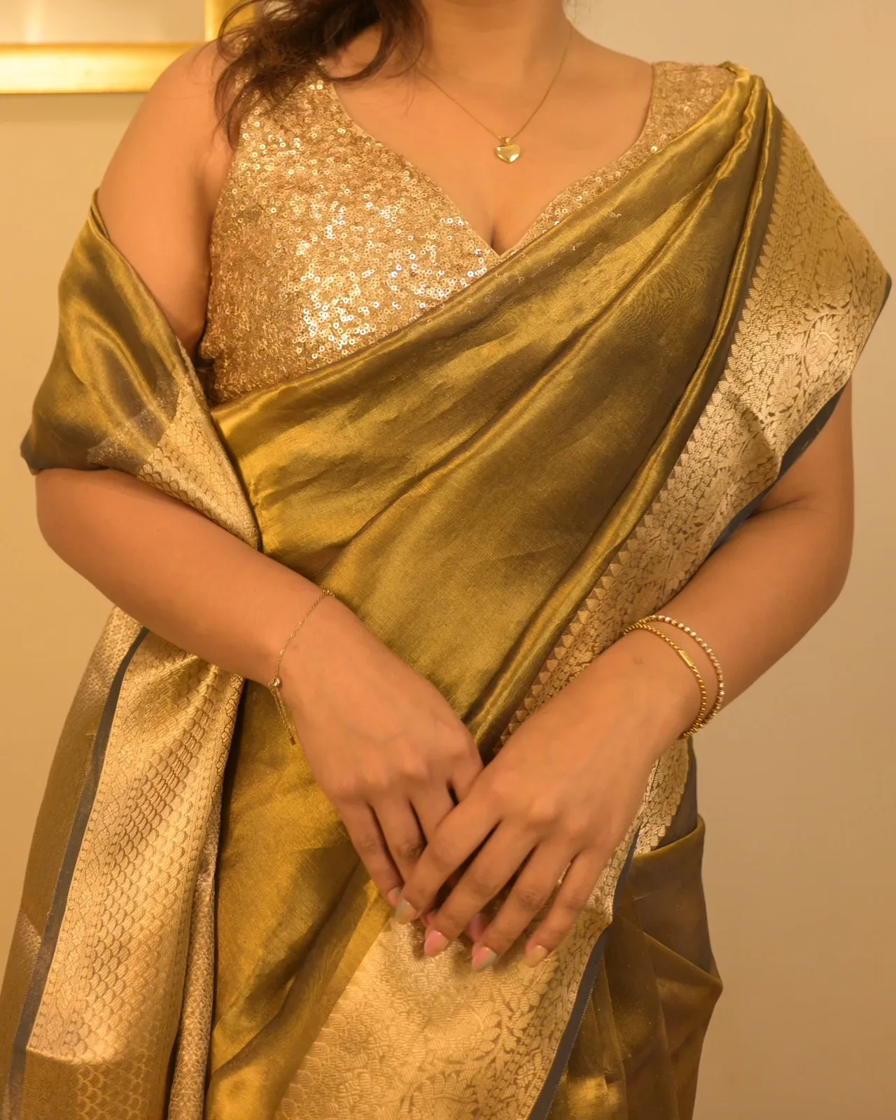 Tissue drape worn with a gold sequin blouse