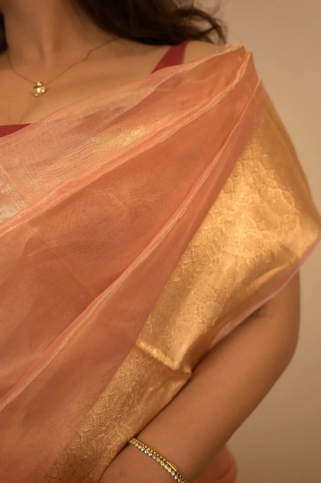 Close-up of the gold brocade border on the sheer peach tissue