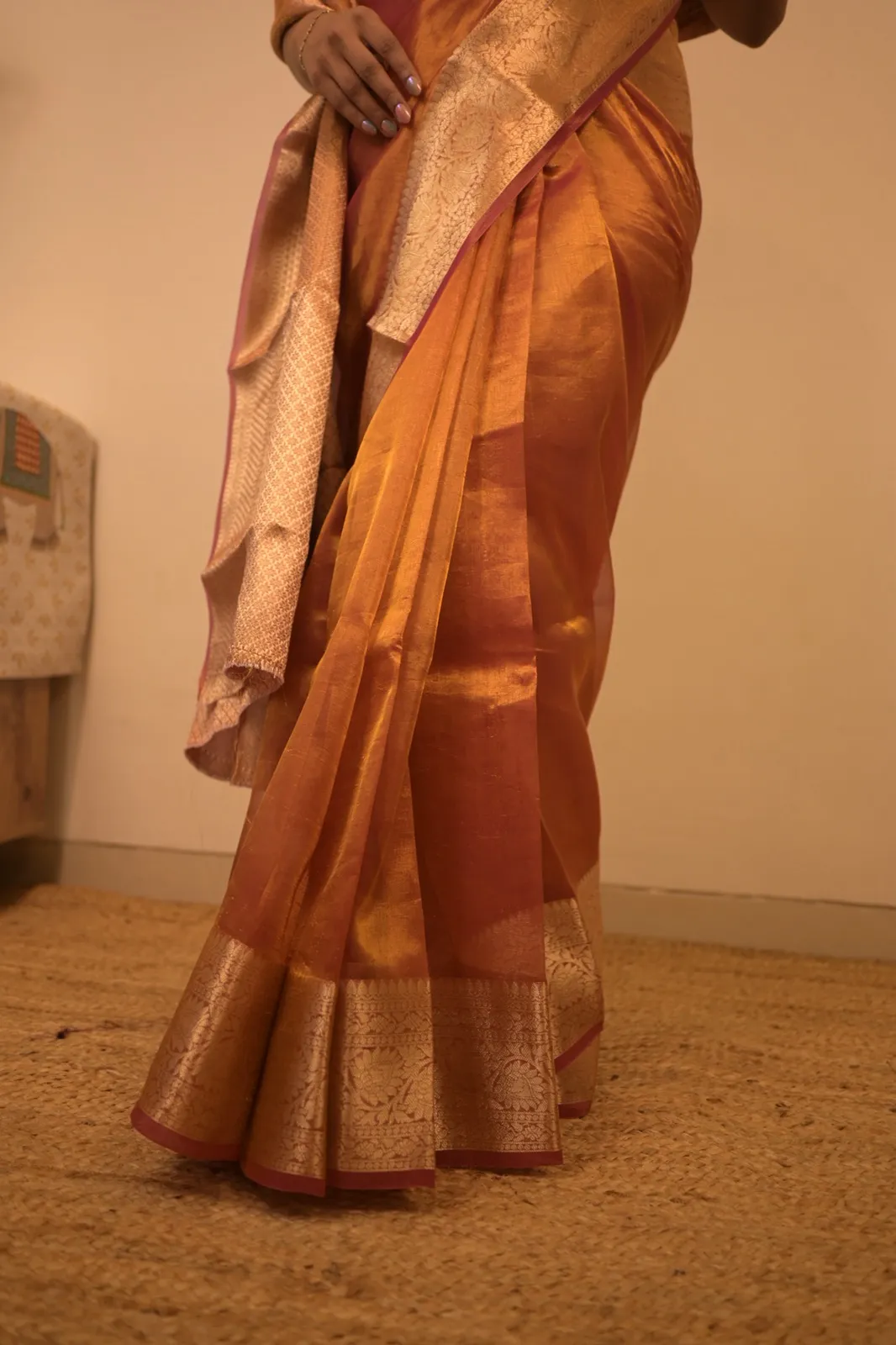 Rust red tissue silk saree with a floral brocade border